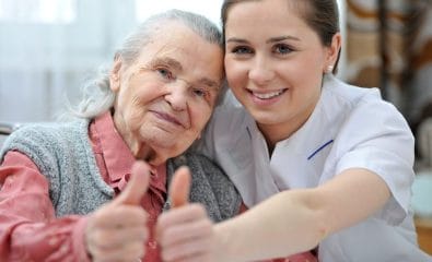 18916077 - senior woman and female nurse are showing thumbs up